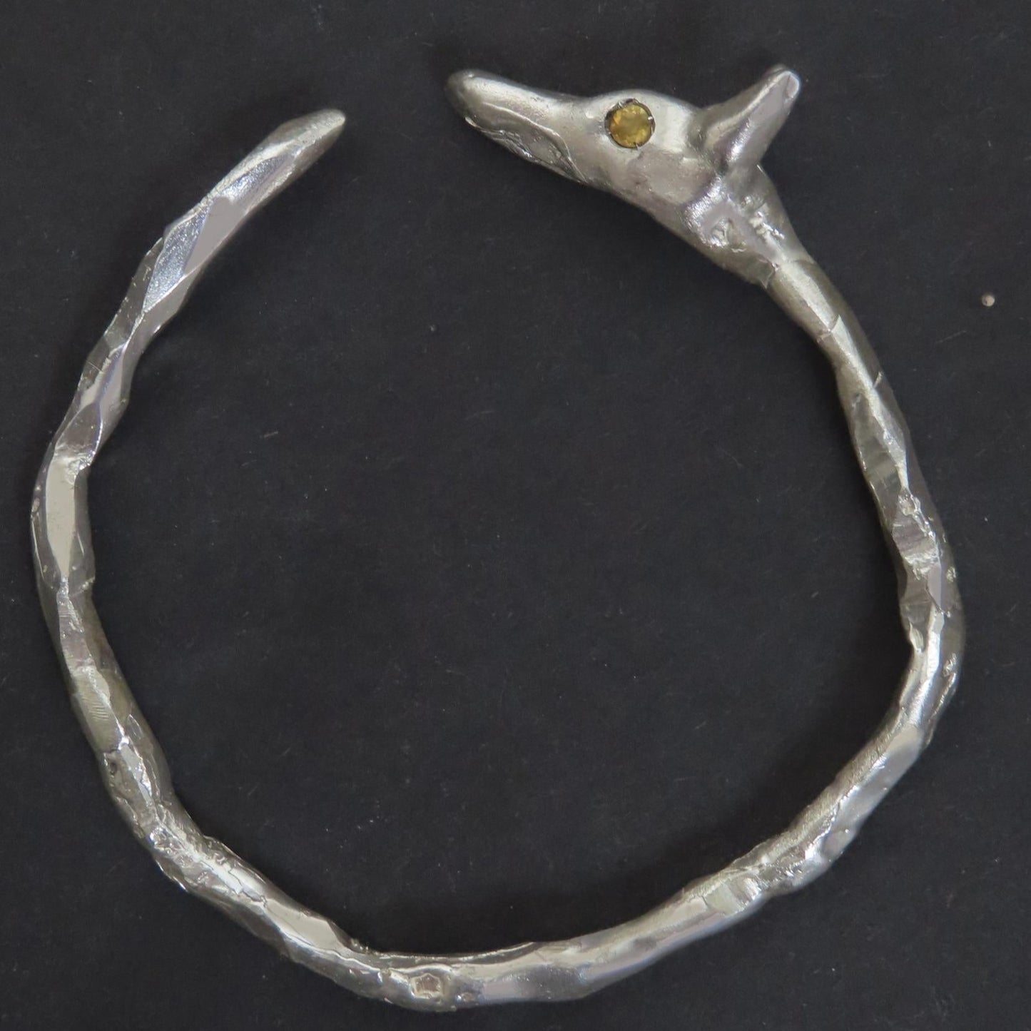 handmade silver bangle sculpted to look like a jackal with citrine eyes