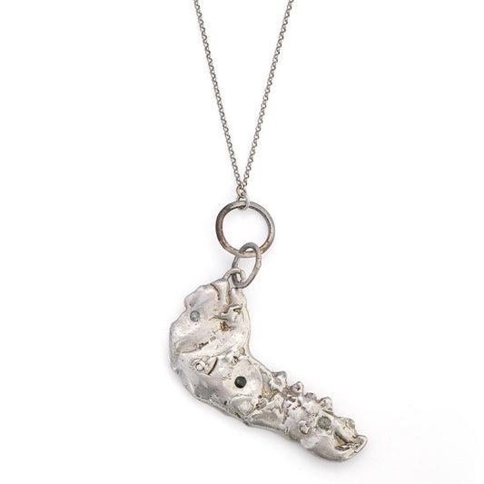 pendant in the shape of a jawbone with gemstones 